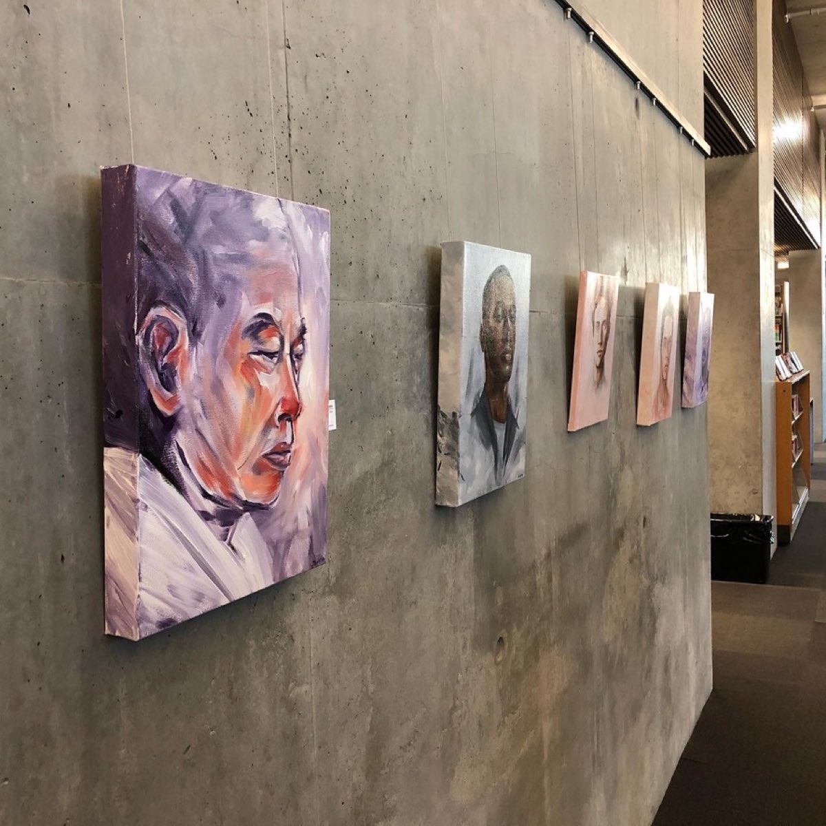 Portrait paintings along the gallery wall