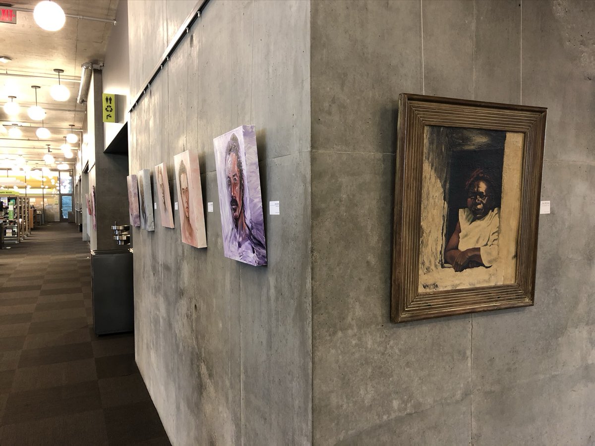 A framed painting in the library gallery